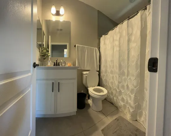 a bathroom with a toilet sink and a mirror