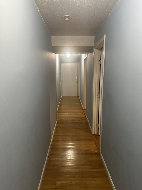 57 Brighton Avenue, Unit B Boston, MA 02134 - Photo 13 of 17 a view of gallery with wooden floor