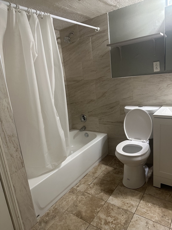 57 Brighton Avenue, Unit B Boston, MA 02134 - Photo 15 of 17 a bathroom with a toilet and a shower