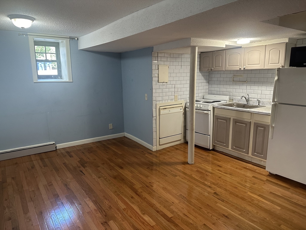57 Brighton Avenue, Unit B Boston, MA 02134 - Photo 2 of 17 a kitchen with wooden floors and appliances