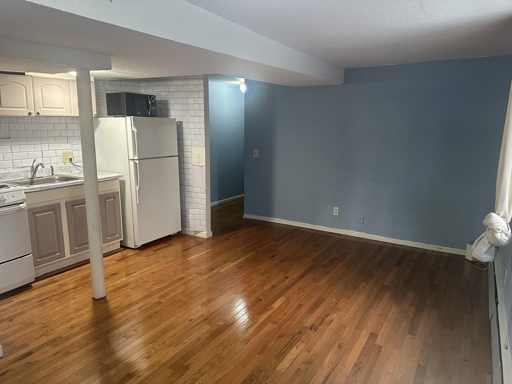 57 Brighton Avenue, Unit B Boston, MA 02134 - Photo 3 of 17 a view of empty room with wooden floor and window