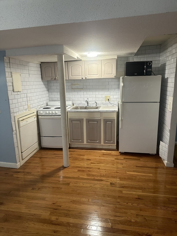57 Brighton Avenue, Unit B Boston, MA 02134 - Photo 5 of 17 a kitchen with stainless steel appliances granite countertop a stove a sink and a refrigerator