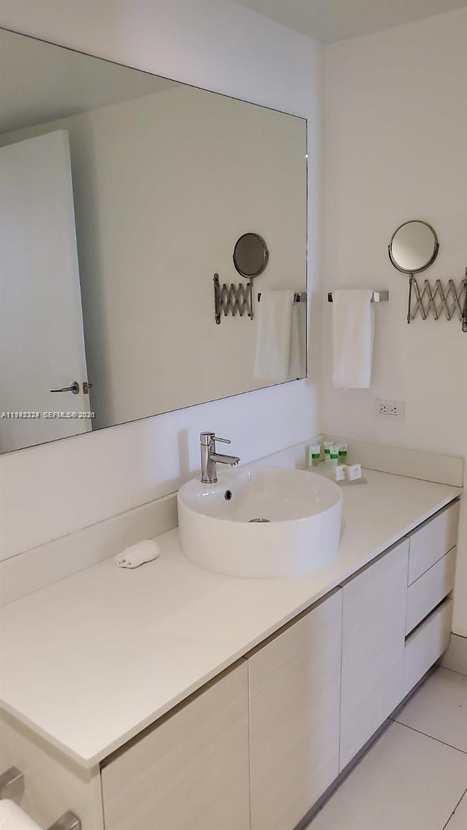2602 East Hallandale Beach Boulevard, Unit R2508 Hallandale Beach, FL 33009 - Photo 10 of 31 a bathroom with a sink and a mirror
