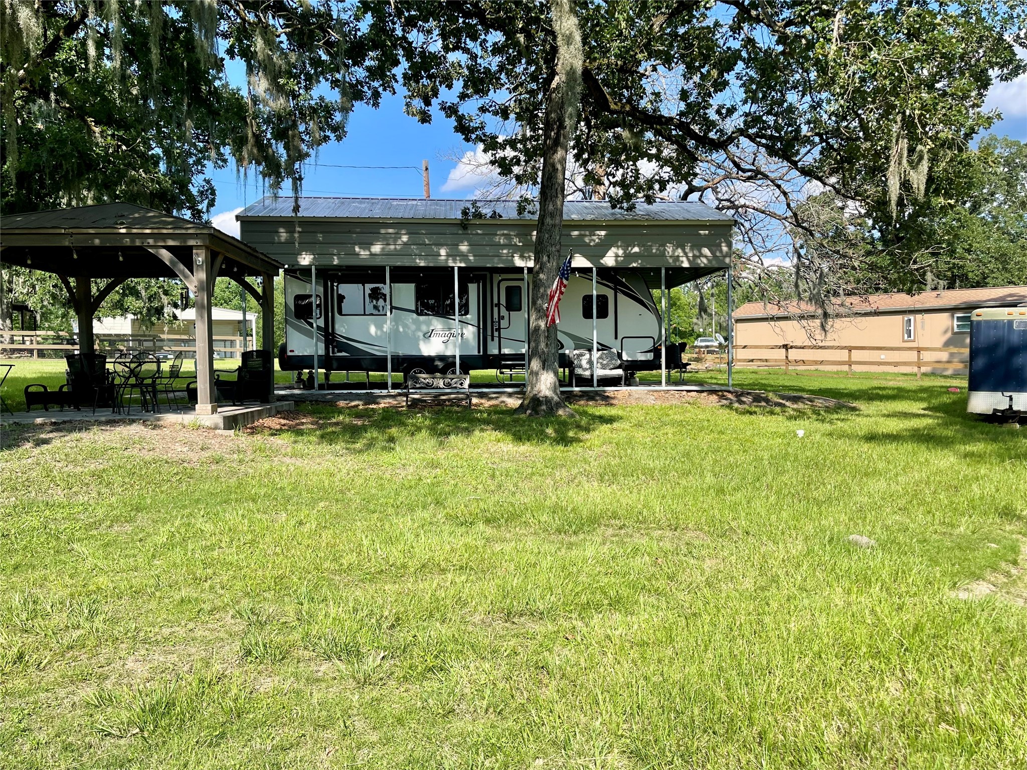 520 Lake Shore Drive Trinity, TX 75862 - Photo 1 of 19 a view of a swimming pool with a table and chairs under an umbrella