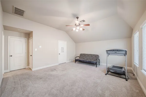 a view of a livingroom with furniture and a ceiling fan