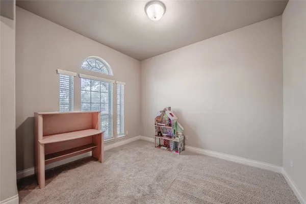 an empty room with furniture and a window