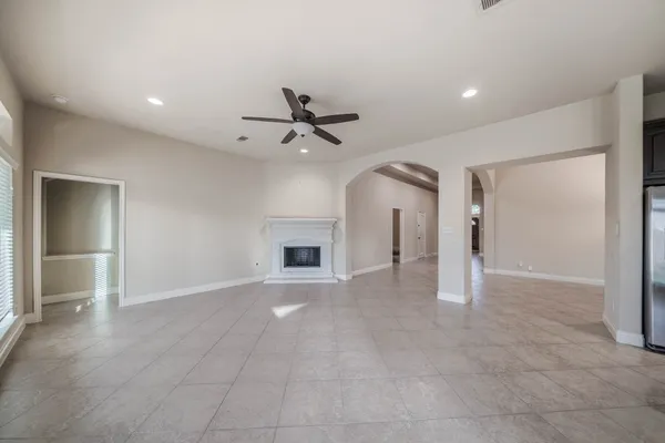 a view of a livingroom with a ceiling fan and window