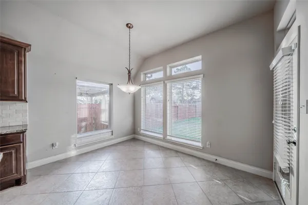 a view of an empty room with a fireplace and a window