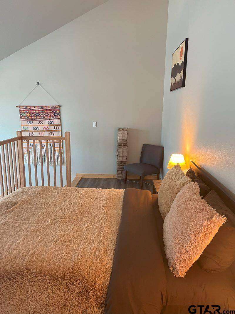 11227 Interstate 20 Tyler, TX 75708 - Photo 13 of 33 a bedroom with a bed and a lamp