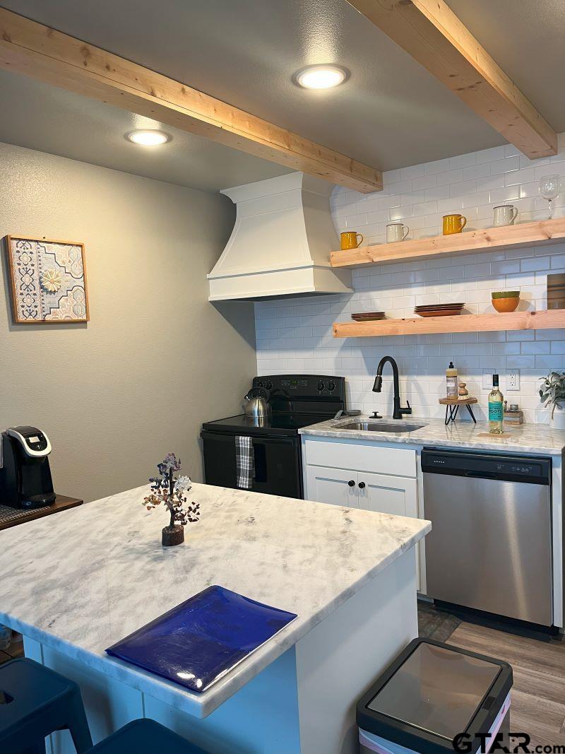 11227 Interstate 20 Tyler, TX 75708 - Photo 23 of 33 a kitchen with a stove a sink and cabinets