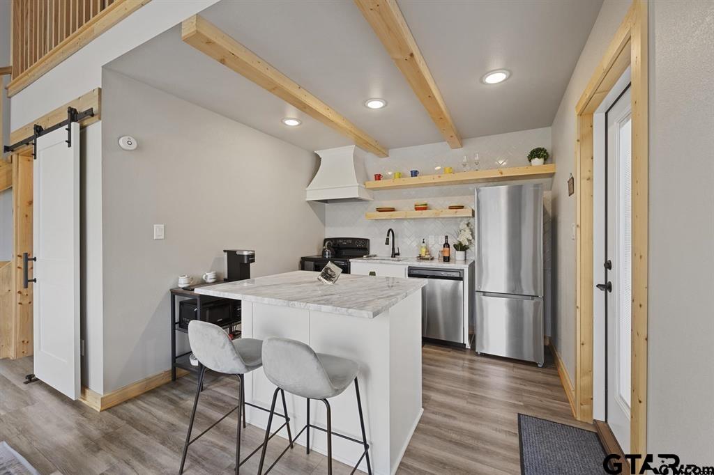 11227 Interstate 20 Tyler, TX 75708 - Photo 28 of 33 a kitchen with refrigerator and chairs
