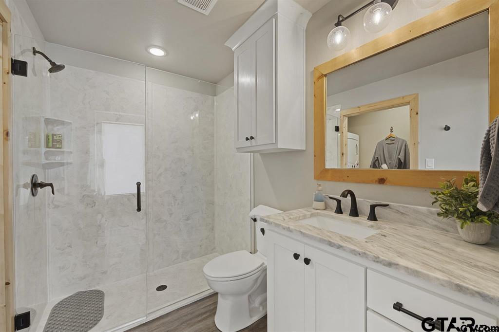 11227 Interstate 20 Tyler, TX 75708 - Photo 32 of 33 a bathroom with a sink a toilet and shower