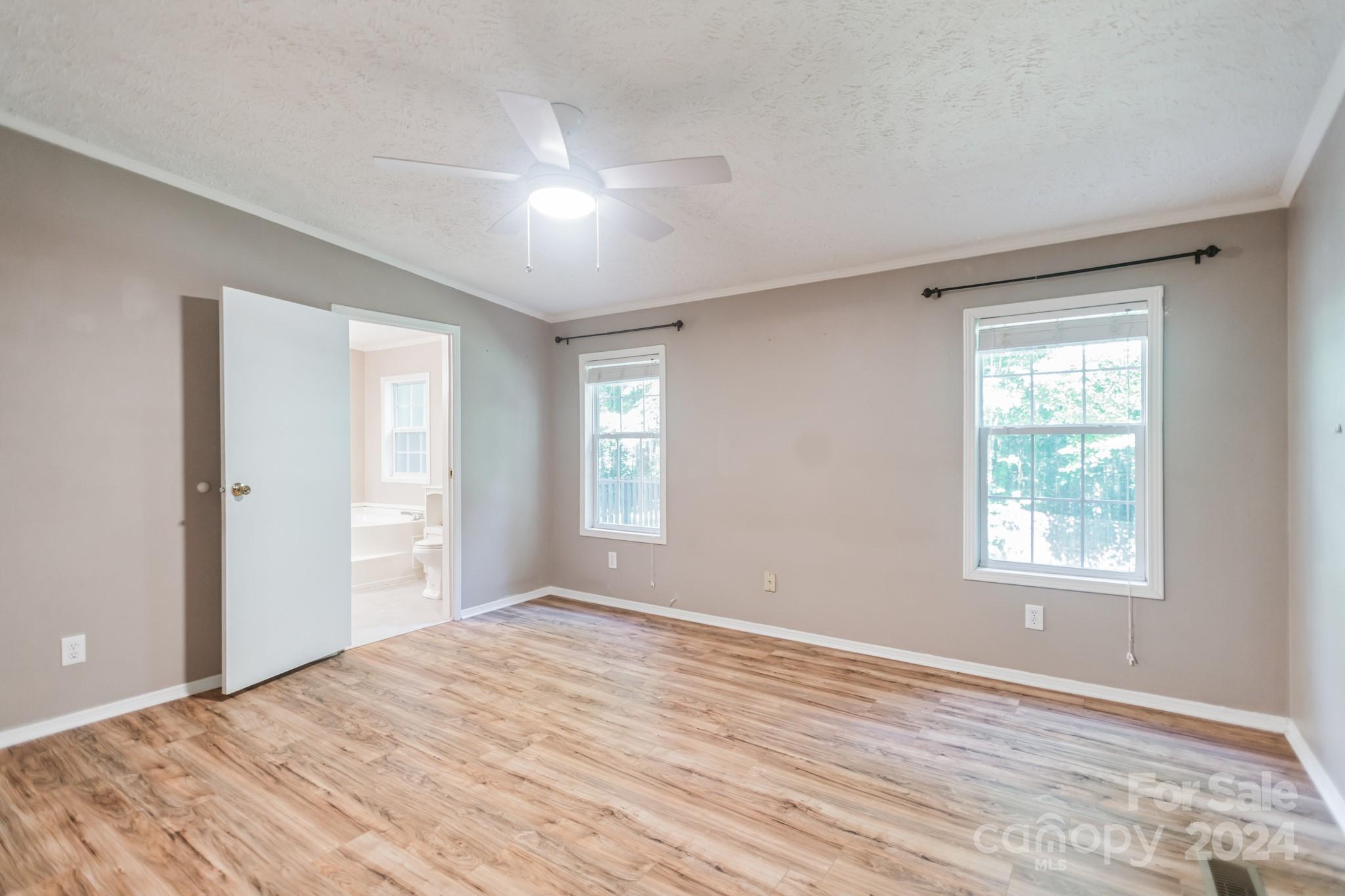 104 Cane Crest Circle Fairview, NC 28730 - Photo 11 of 29 a view of empty room with wooden floor and fan