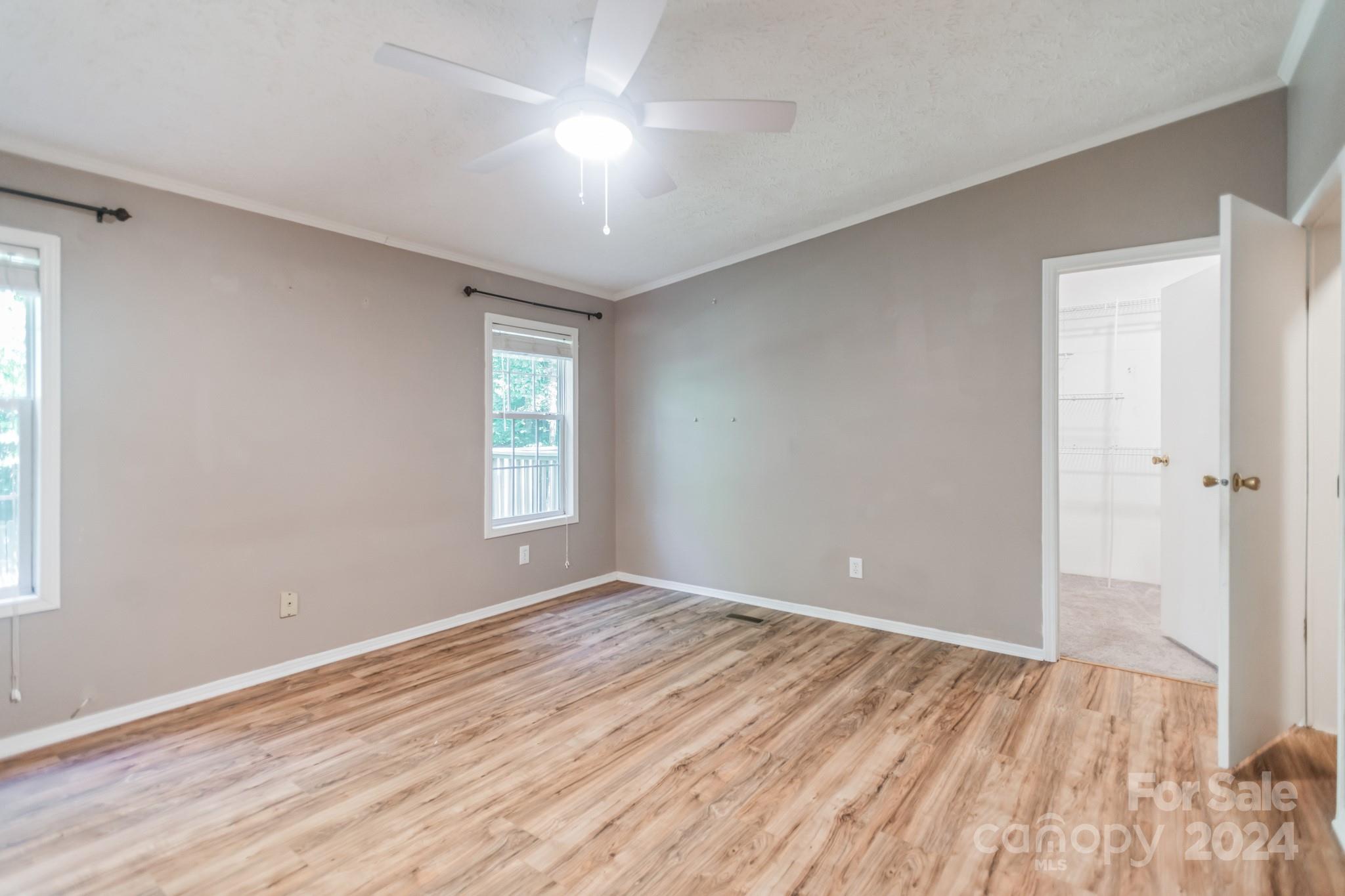 104 Cane Crest Circle Fairview, NC 28730 - Photo 12 of 29 a view of empty room with wooden floor and fan