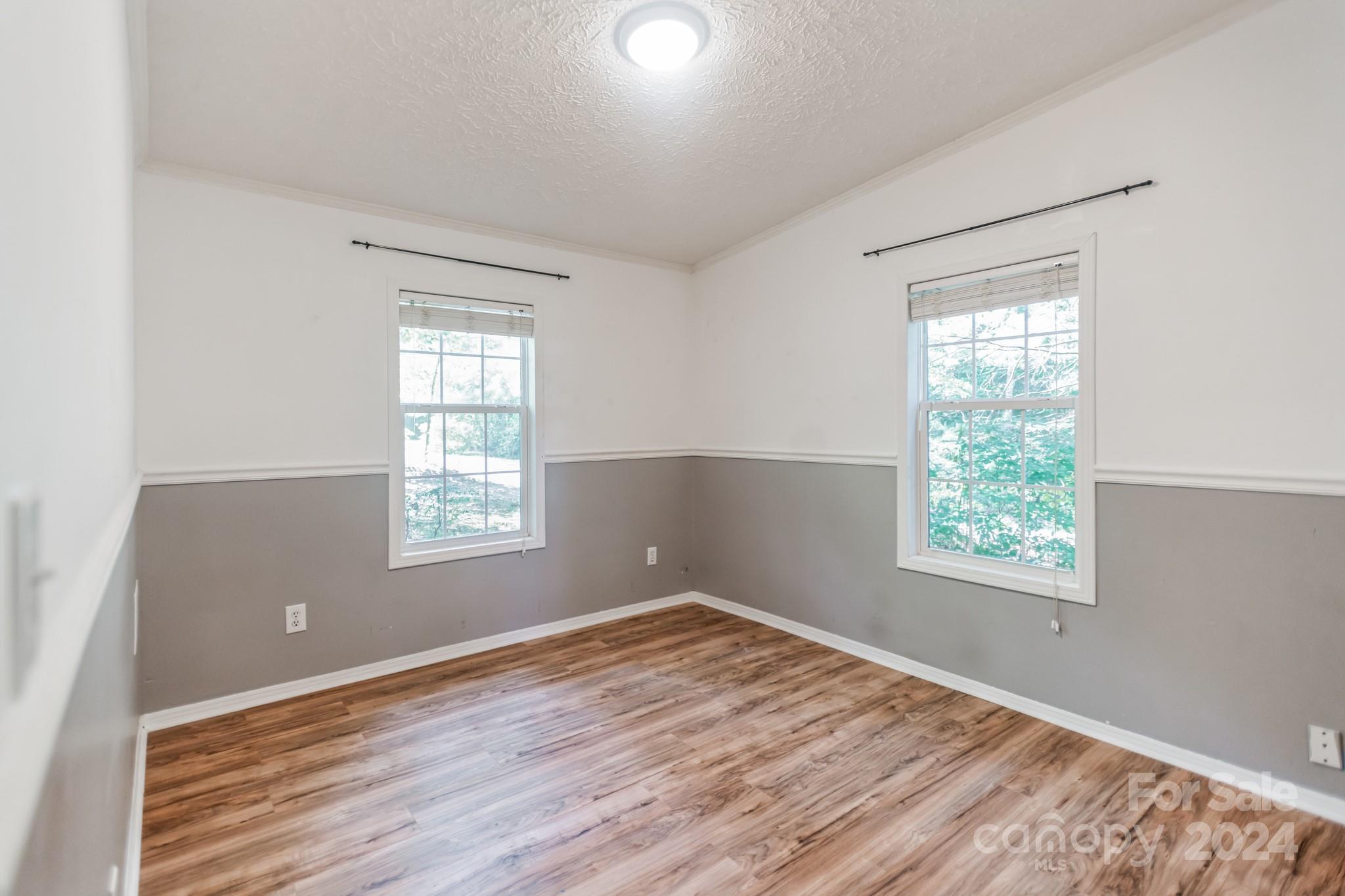 104 Cane Crest Circle Fairview, NC 28730 - Photo 16 of 29 a view of an empty room with wooden floor and a window