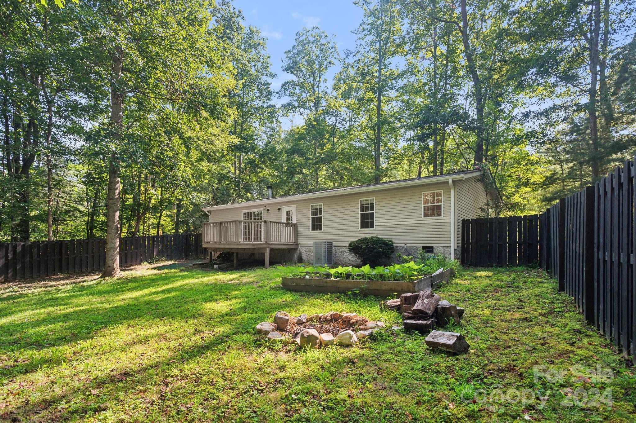 104 Cane Crest Circle Fairview, NC 28730 - Photo 21 of 29 a backyard of a house with yard and outdoor seating