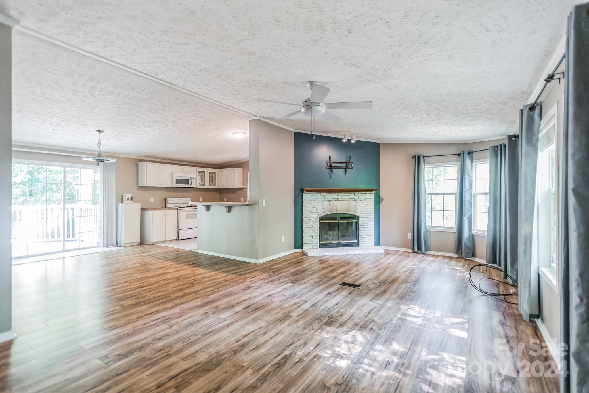 104 Cane Crest Circle Fairview, NC 28730 - Photo 3 of 29 a large bedroom with a large bed and a fireplace