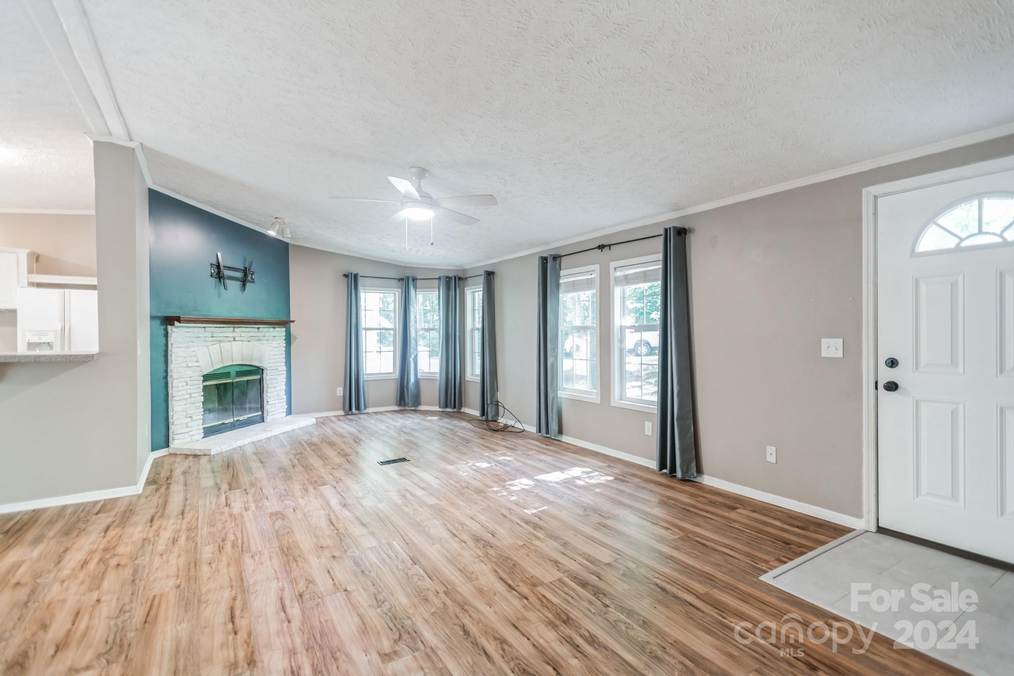 104 Cane Crest Circle Fairview, NC 28730 - Photo 10 of 29 a view of empty room with wooden floor and fireplace