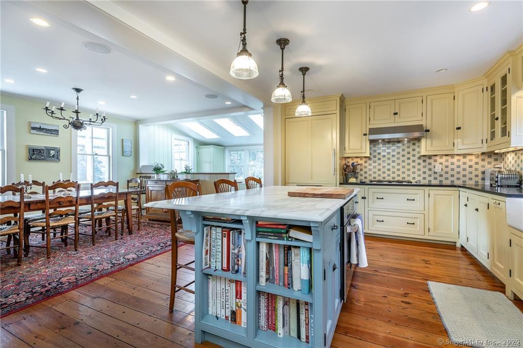 32 Leach Hollow Road Sherman, CT 06784 - Photo 11 of 40 a large kitchen with lots of wooden furniture a sink a dining table and chairs