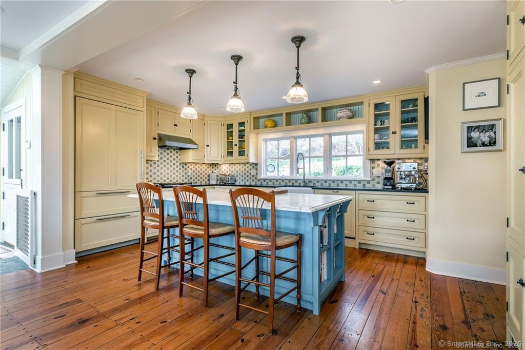 32 Leach Hollow Road Sherman, CT 06784 - Photo 12 of 40 a kitchen with granite countertop white cabinets and stainless steel appliances