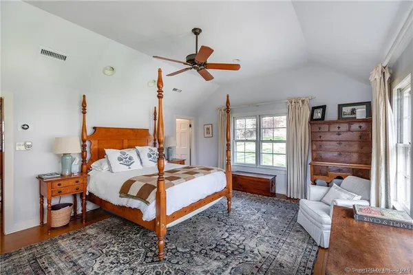 a bedroom with a bed and a couch