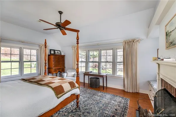 a bathroom with a granite countertop toilet sink and mirror