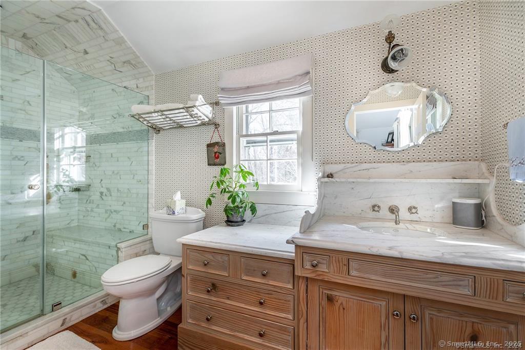 32 Leach Hollow Road Sherman, CT 06784 - Photo 18 of 40 a bathroom with a granite countertop toilet sink and mirror