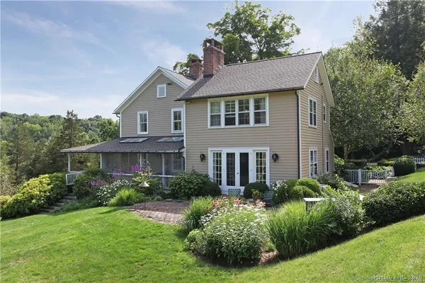 a aerial view of a house next to a yard