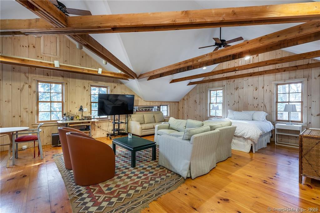32 Leach Hollow Road Sherman, CT 06784 - Photo 25 of 40 a living room with furniture a flat screen tv and a table