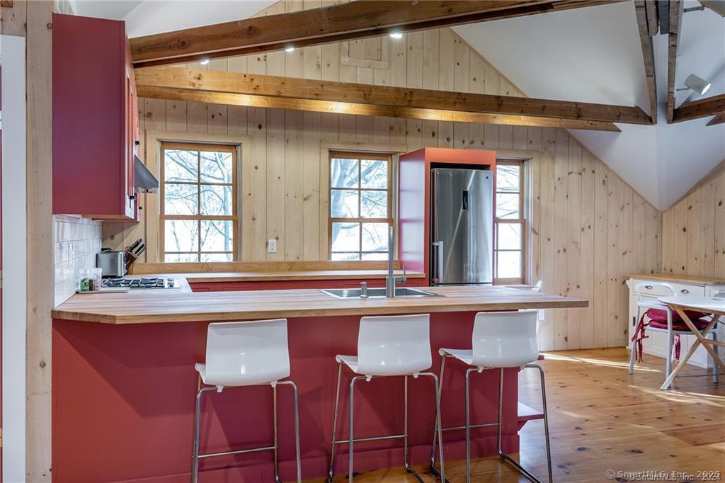 32 Leach Hollow Road Sherman, CT 06784 - Photo 26 of 40 a kitchen with a dining table and chairs