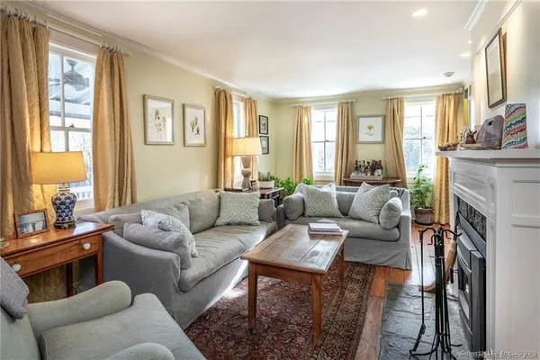 a large kitchen with lots of wooden furniture a sink a dining table and chairs