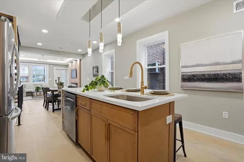 a kitchen with stainless steel appliances granite countertop a stove and a sink