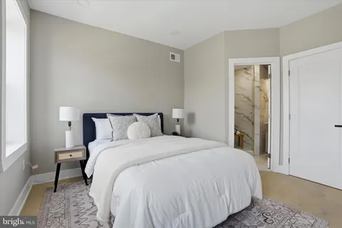a bedroom with a large window and a balcony