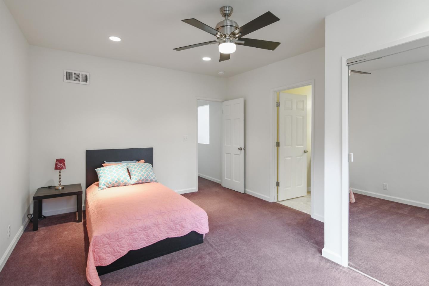 144 Eagle Crest Drive Scotts Valley, CA 95066 - Photo 18 of 28 a bedroom with a bed and a chandelier
