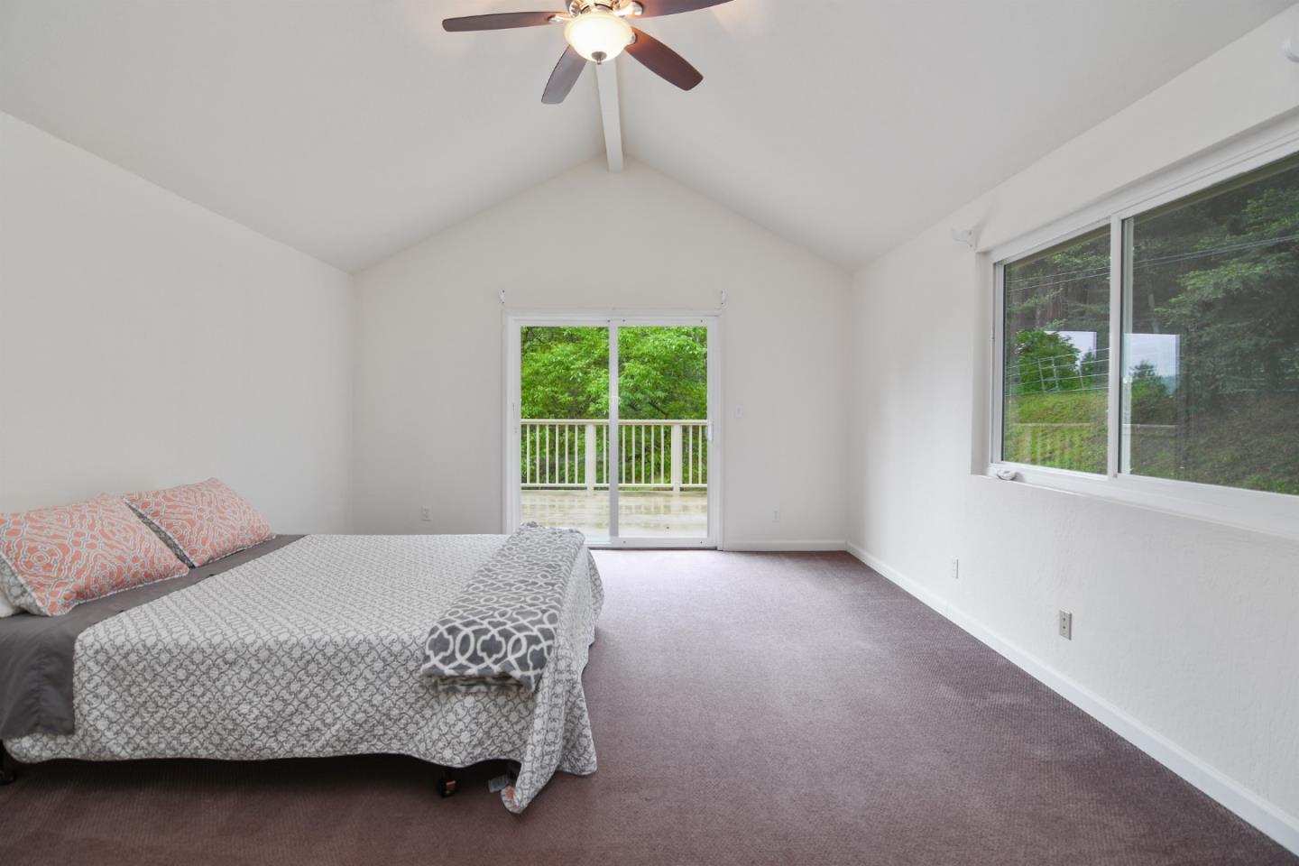 144 Eagle Crest Drive Scotts Valley, CA 95066 - Photo 20 of 28 a bedroom with a bed a chandelier and a window