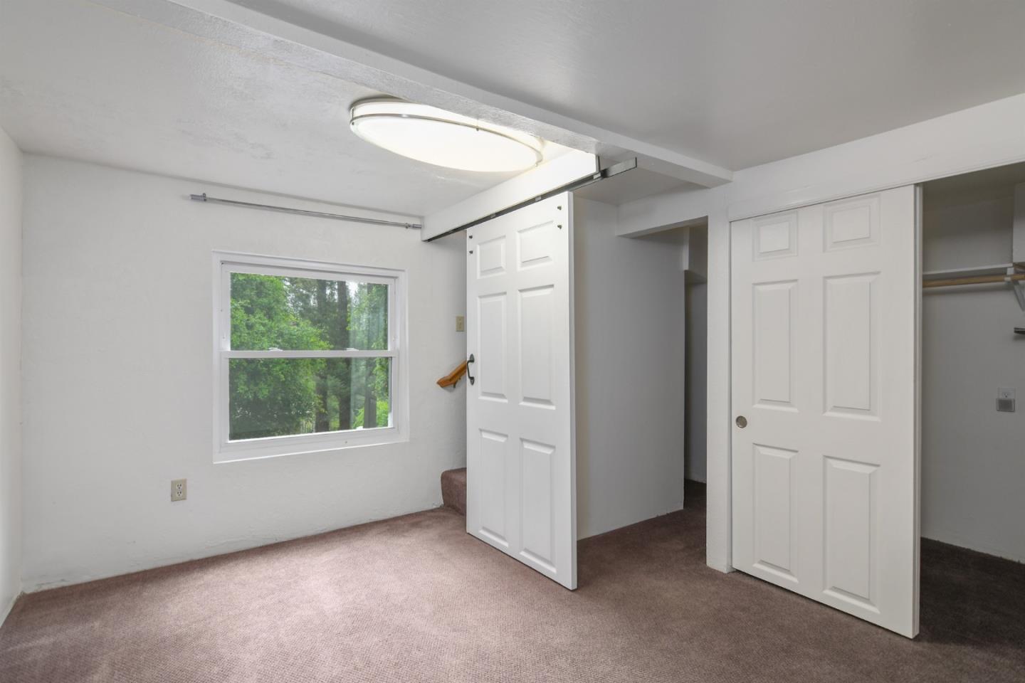 144 Eagle Crest Drive Scotts Valley, CA 95066 - Photo 22 of 28 an empty room with windows and closet