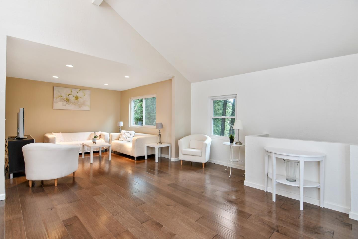 144 Eagle Crest Drive Scotts Valley, CA 95066 - Photo 7 of 28 a living room with couches and kitchen view with wooden floor