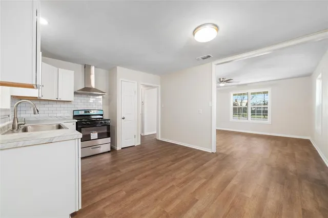 a kitchen with granite countertop a stove and a sink