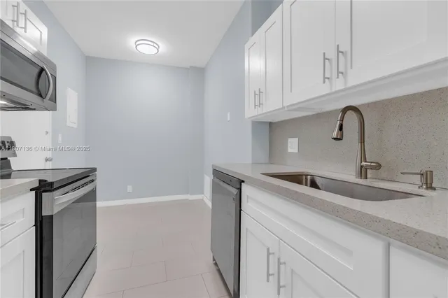 a kitchen with a sink and cabinets