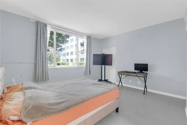 a bedroom with a bed and a chair