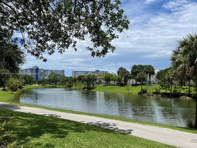 a view of a lake with houses in the back