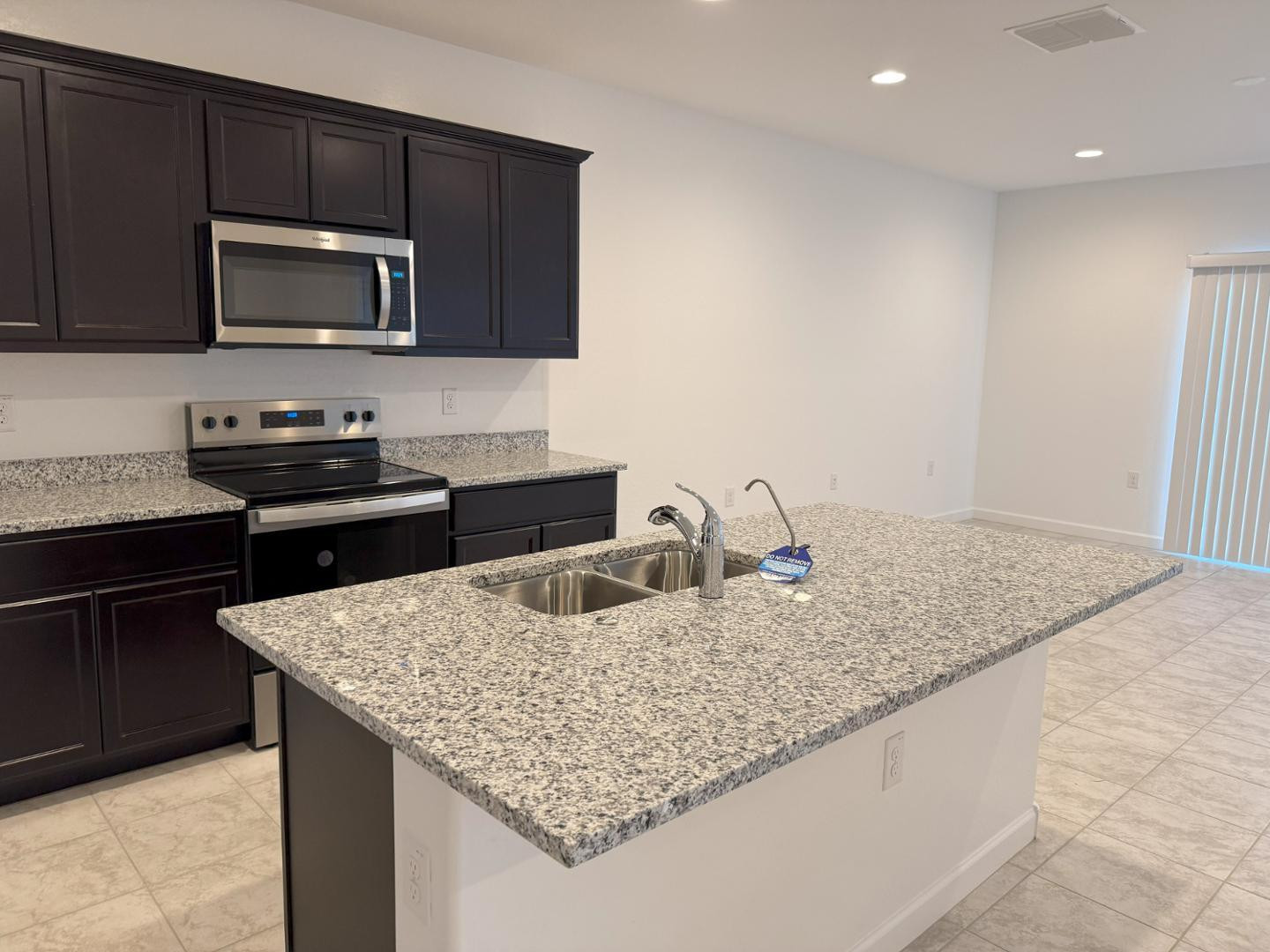 1840 West Spaulding Avenue Apache Junction, AZ 85120 - Photo 24 of 53 a kitchen with granite countertop stainless steel appliances microwave stove refrigerator and sink