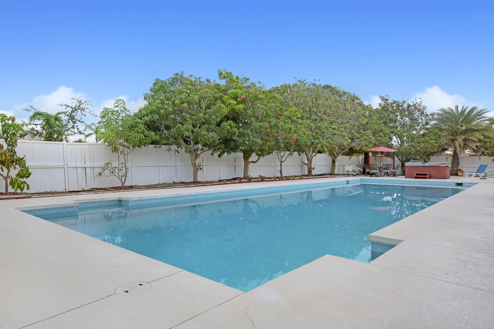 299 Palm Avenue Jupiter, FL 33477 - Photo 18 of 26 a view of a swimming pool with a yard