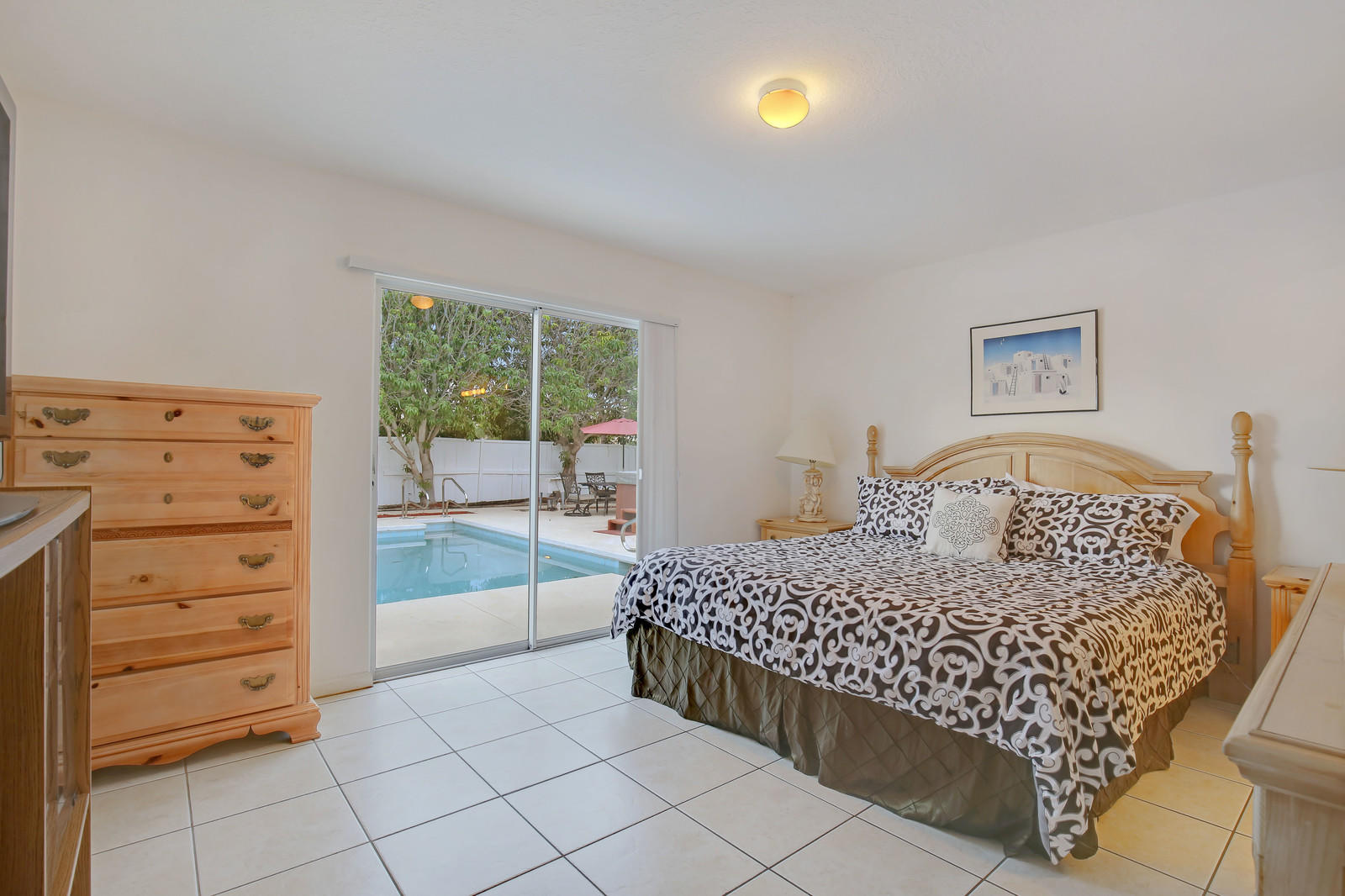 299 Palm Avenue Jupiter, FL 33477 - Photo 10 of 26 a bedroom with a bed and a cabinets