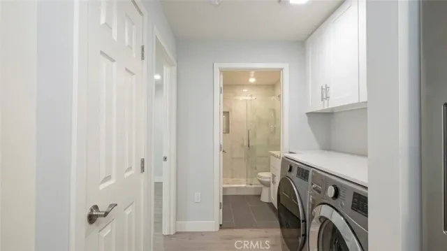 a utility room with a sink dryer and washer