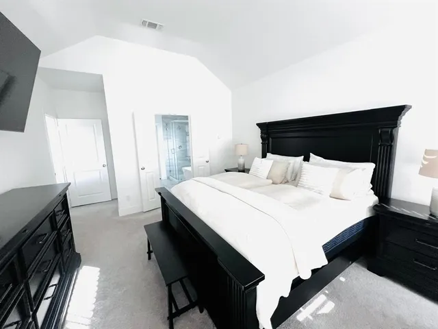 a bedroom with a bed and a tv