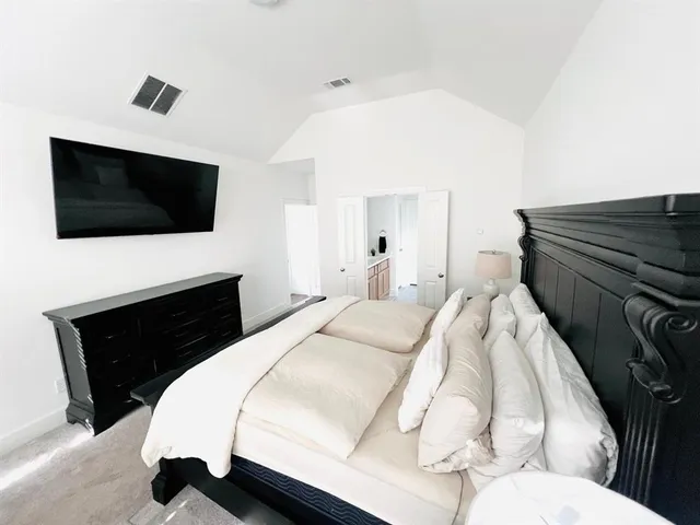 a bedroom with a bed and a flat screen tv