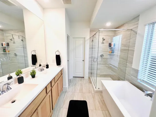 a bathroom with a double vanity sink and mirror