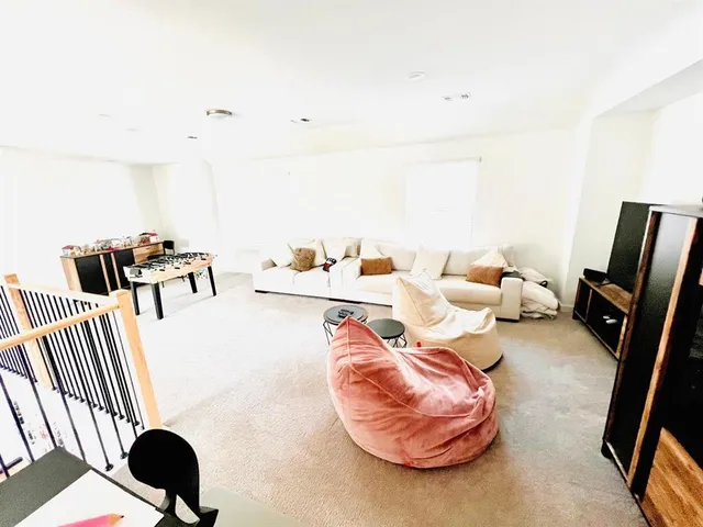 a living room with furniture and a mirror