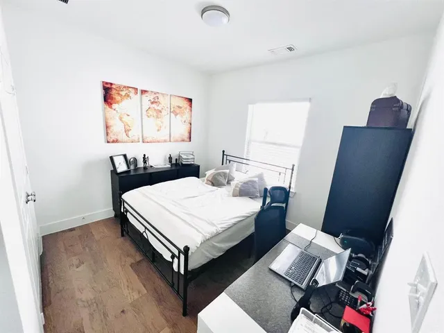 a bed room with a bed and a chair